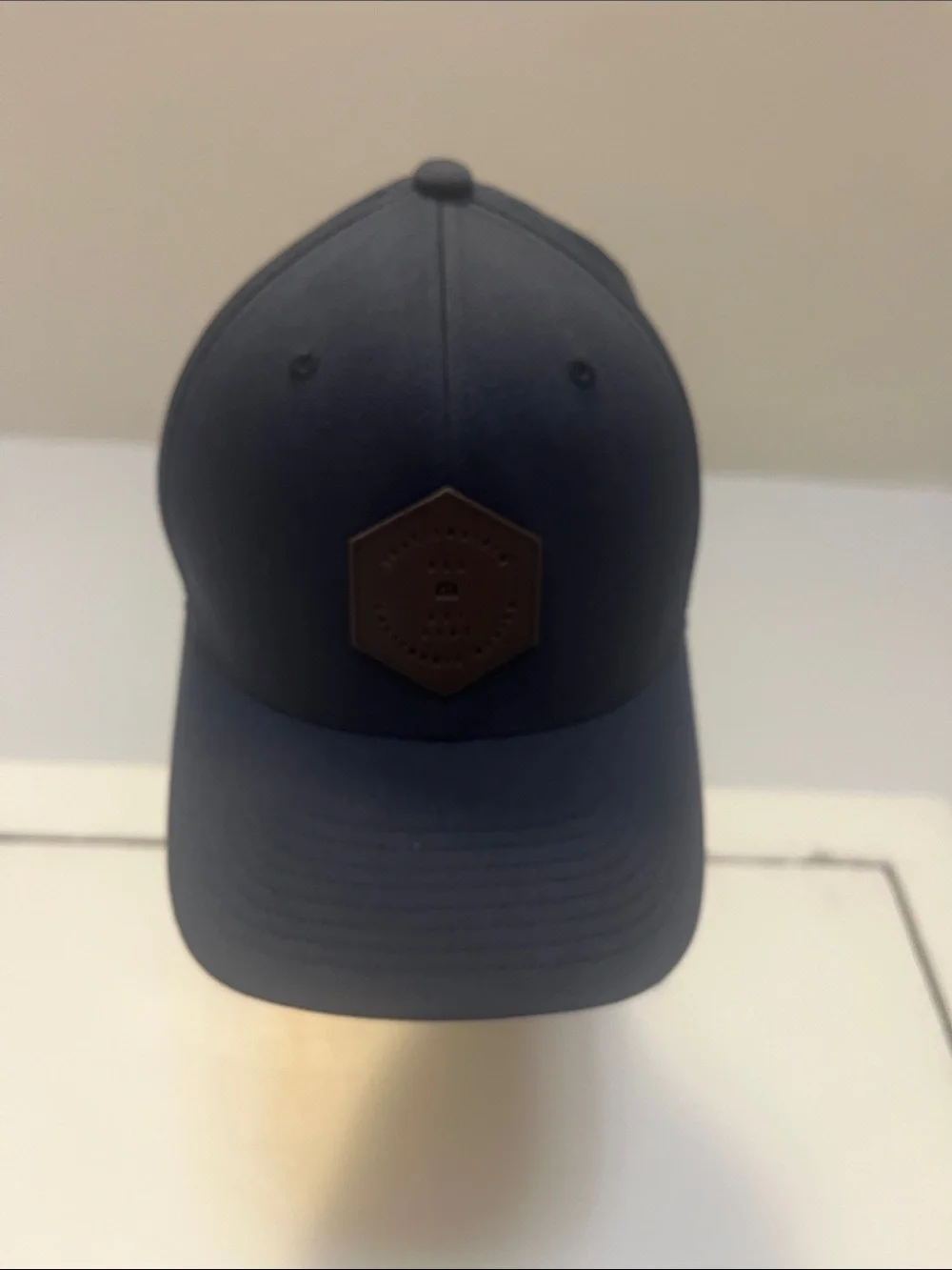Travis Mathew Navy Blue Baseball Cap with Brown Hex Patch